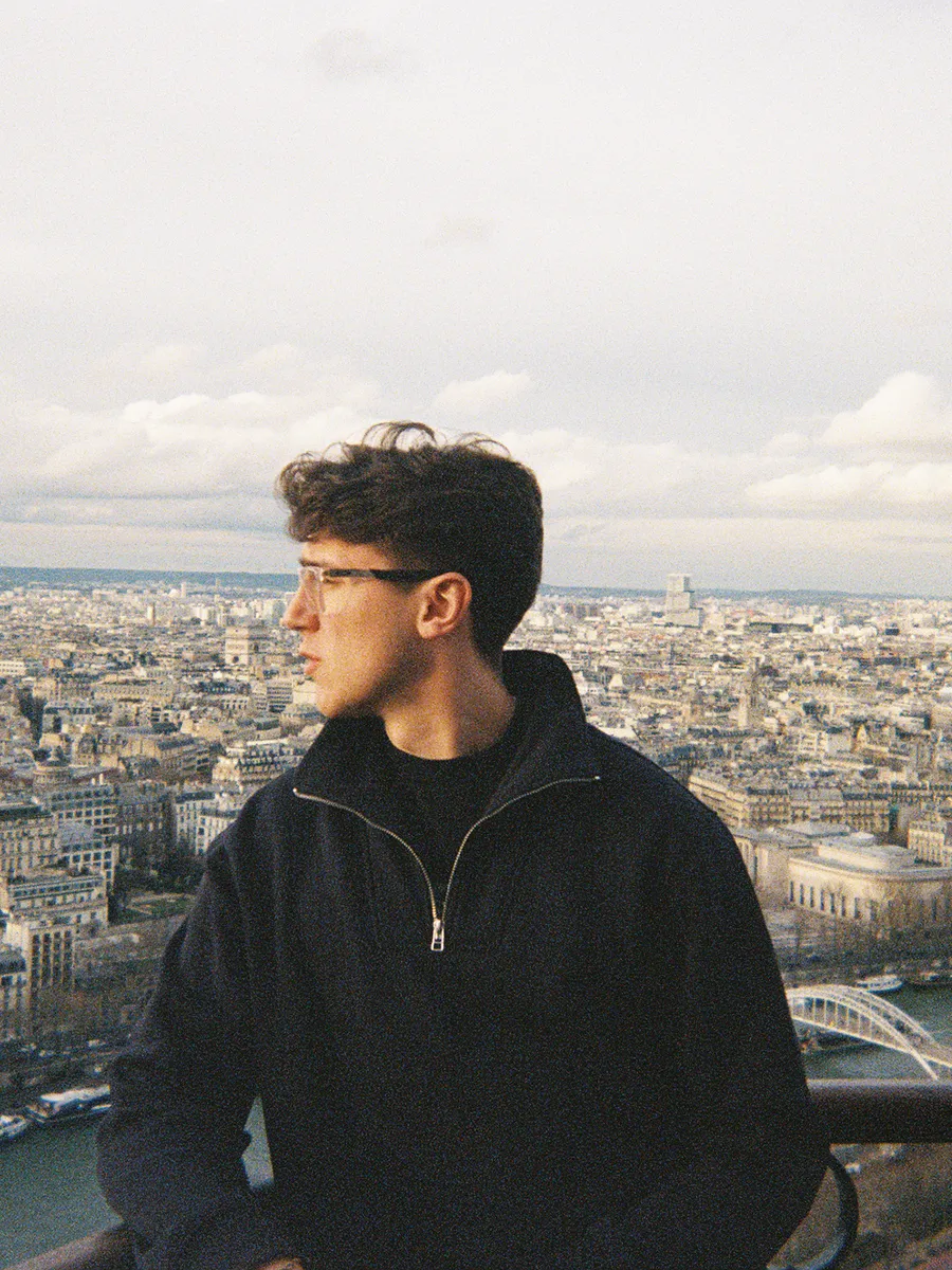 Aidan on the Eiffel Tower, looking out over Paris. Film photo.